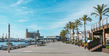 Tarragona, Spain - December 29, 2021: A view of the promenade by the sea at El Serrallo in Tarragona, Spain. El Serrallo is the traditional fishermen district in the city