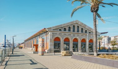 Tarragona, Spain - December 29, 2021: A view of the old shelds in the public area of the Moll de Costa dock in the Port of Tarragona, in Spain