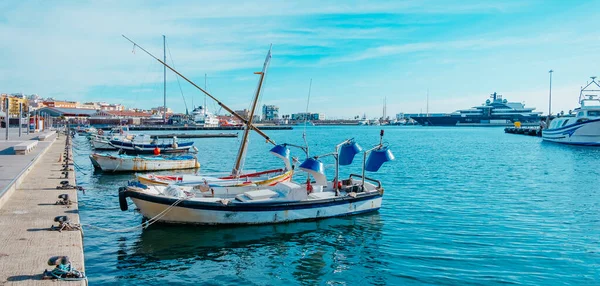 some fishing boats moored at the port in El Serrallo, the traditional fishermen district in Tarragona, Spain, in a panoramic format to use as web banner or header 