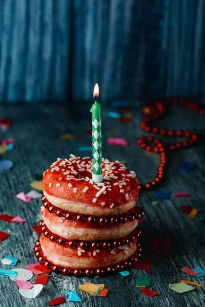 Uma Pilha Donuts Com Uma Geada Vermelha Com Uma Vela — Fotografia de Stock