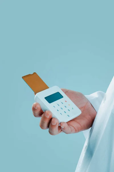 白衣を着た白人医師がクレジットカードを挿入した無線決済端末を持っていて — ストック写真