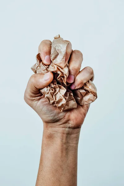 Man Squeezes Ball Crumpled Brown Paper His Hand White Background — Stock Photo, Image