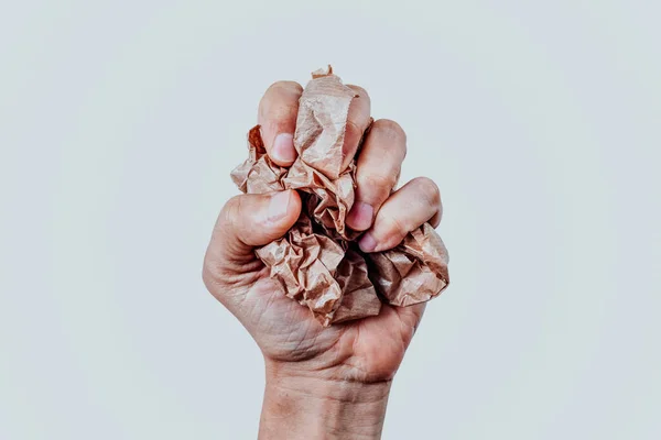 Closeup Man Squeezing Ball Brown Paper His Hand Front White — Stock Photo, Image