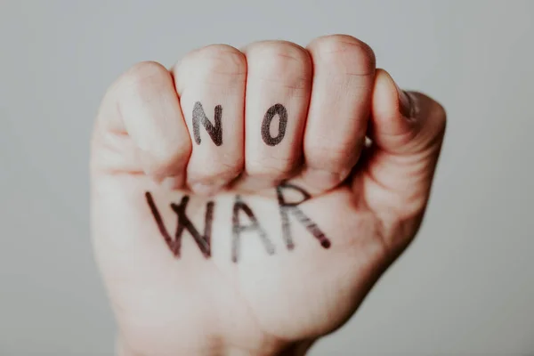 Closeup Raised Fist Man Text War Written Gray Background — Stock Photo, Image