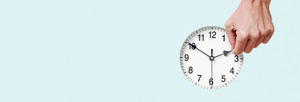 Closeup Man Setting Clock Backwards Forwards Pale Blue Background Some — Stock Photo, Image