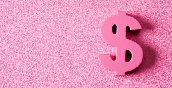 a pink dollar sign, depicting concepts such as pink money or pink capitalism, on a textured pink background with some blank space on the left