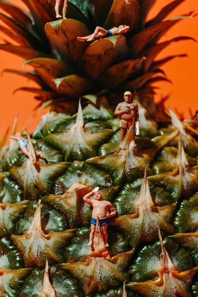 Closeup Some Miniature People Wearing Swimsuit Pineapple Orange Background — Stock Photo, Image