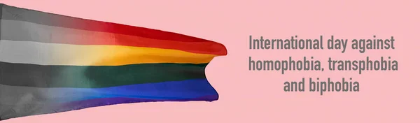 一个彩虹骄傲旗和文字国际日反对同性恋恐惧症 变性恐惧症和生物恐惧症的粉色背景 以全景格式作为网页横幅 — 图库照片