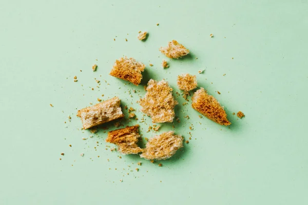 High Angle View Some Pieces Crumbs Multigrain Toast Green Background — Stock Photo, Image