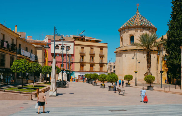 Lucena, Spain - May 27, 2022: A view over the Plaza de San Miguel square, in Lucena, Spain, highlighting the Parroquia de San Mateo church on the right