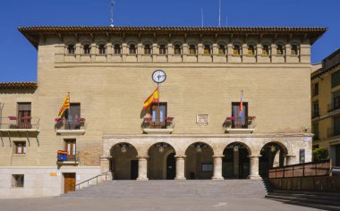 Monzon, Spain - June 28, 2022: The facade of the historic Ayuntamiento or Casa Consistorial, the city hall, of Monzon, in Huesca, Aragon, Spain, in the Plaza Mayor square, in the old town of the city