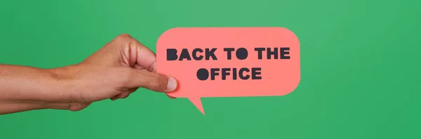 Man Holds Pink Paper Sign Reads Text Back Office Green — ストック写真