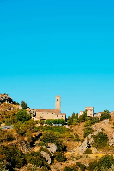 a view of the small town Vilanova de Prades, in Catalonia, Spain, highlighting the belfry of the Sant Salvador Church