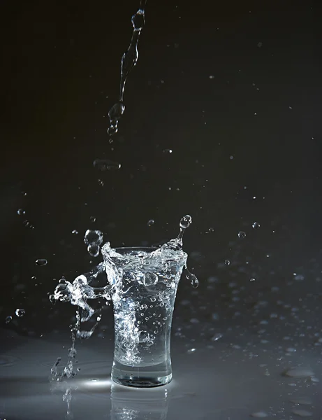 Vodka glass with splashes — Stock Photo, Image