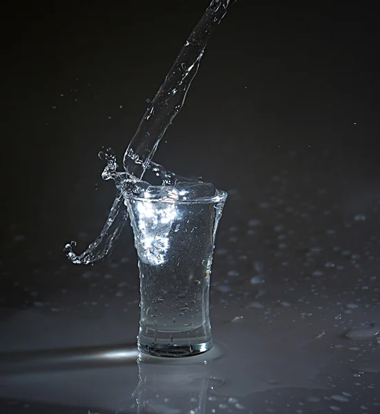 Vodka glass with splashes — Stock Photo, Image