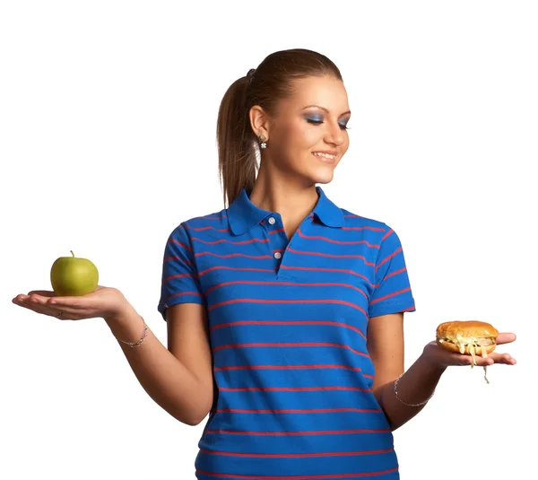 Woman with hamburger and apple — Stock Photo, Image