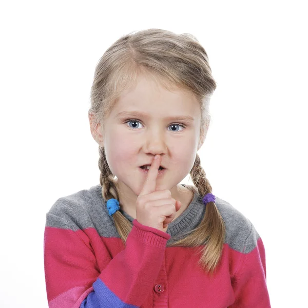 Portrait of little girl with silence gesture — Stock Photo, Image