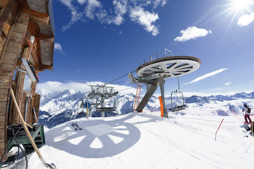Ski chair-lift arrival in alpine mountain