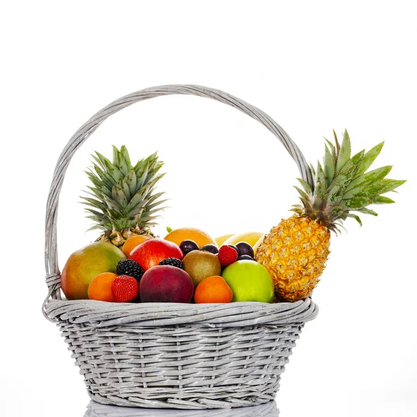 Разноцветные фрукты в плетеной корзине — стоковое фото