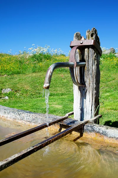 Fountain with drinking water and blu sky — Stock Photo, Image