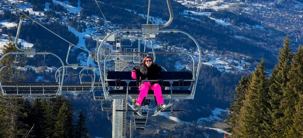 Women on chair lift in french alps, Europe