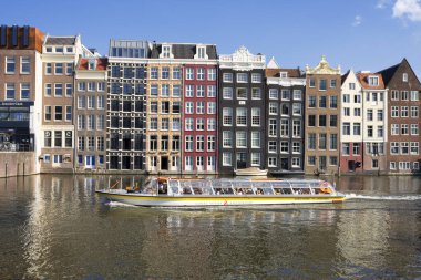 Famous cityscape with boat in Amsterdam, Netherlands, Europe.