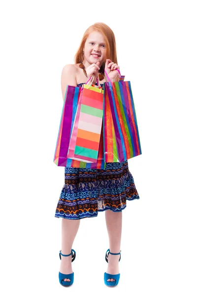 Child shopping. Happy fashion little redhead girl with shopping — Stock Photo, Image