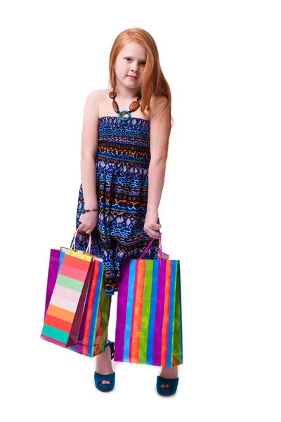 Child shopping. Happy fashion little redhead girl with shopping — Stock Photo, Image