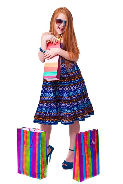 Gelukkig mode roodharige meisje met shopping tassen. — Stockfoto