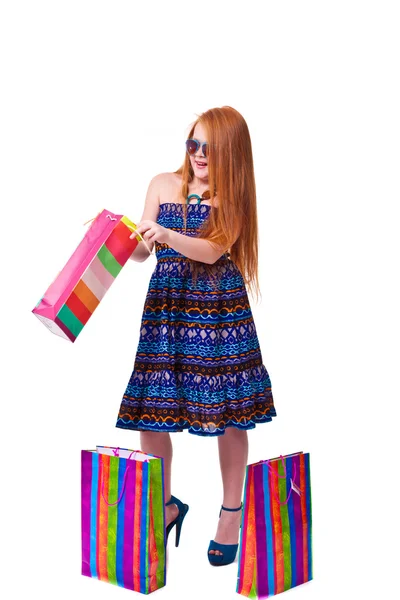 Happy fashion little redhead girl with shopping bags. — Stock Photo, Image