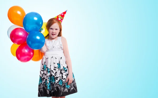 Happy little girl with balloons on blue background — Stock Photo, Image