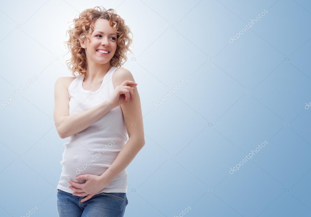 smiling pregnant woman on blue background