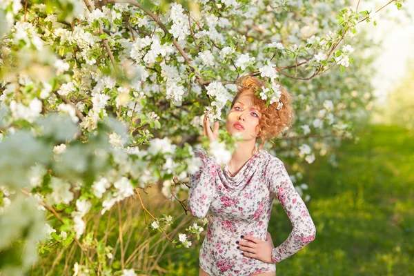 Beautiful blonde in a spring garden — Stock Photo, Image