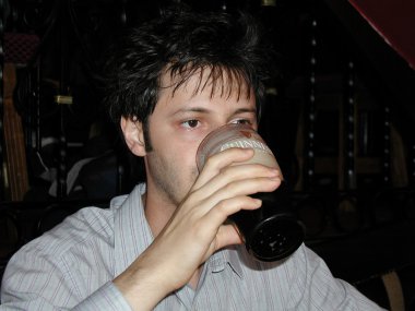 Man drinking Guinness clipart