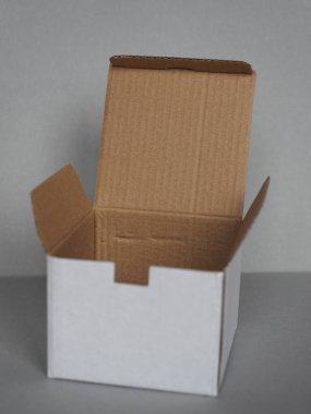 Gri duvarın önündeki boş karton kutu