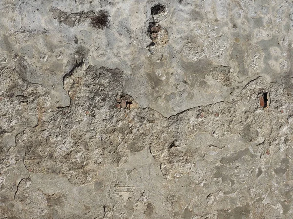 plaster peeling off a damaged wall surface