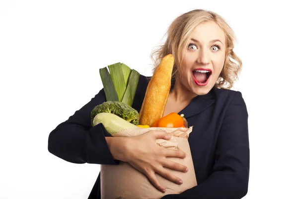 Woman holding a shopping bag full of vegetarian food — Stock Photo, Image