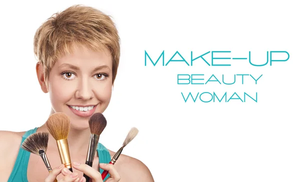 Positive blond with makeup brushes. in studio — Stock Photo, Image