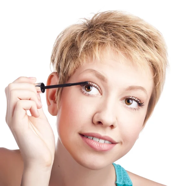 Young woman paints the eyelashes — Stock Photo, Image