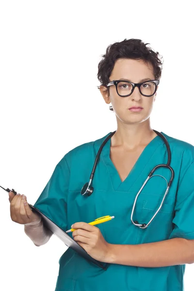 Young doctor writes a diagnosis. Studio — Stock Photo, Image