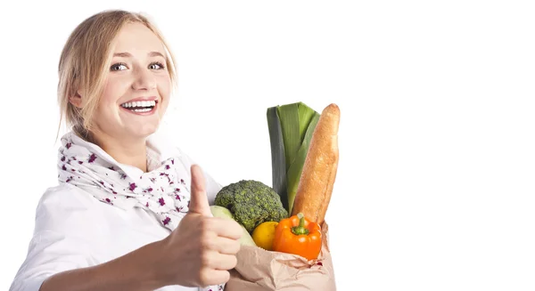 Smiling young woman holding a shopping bag — Stock Photo, Image