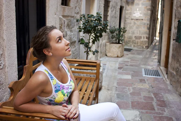 Portrait of a young woman smiling on urban background — Stock Photo, Image