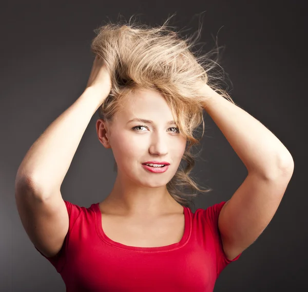 Young attractive blonde is in a studio. Happy smile. — Stock Photo, Image