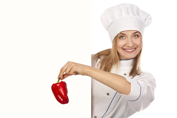 Νέους ελκυστικές μάγειρας κατέχει ένα πιπέρι. χορτοφαγικό γεύμα — Φωτογραφία Αρχείου