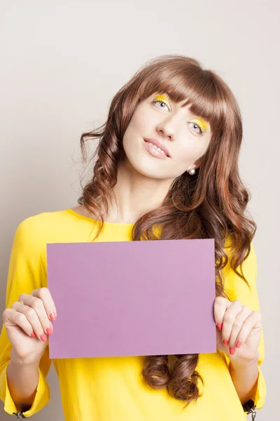 Positive attractive female with a poster — Stock Photo, Image