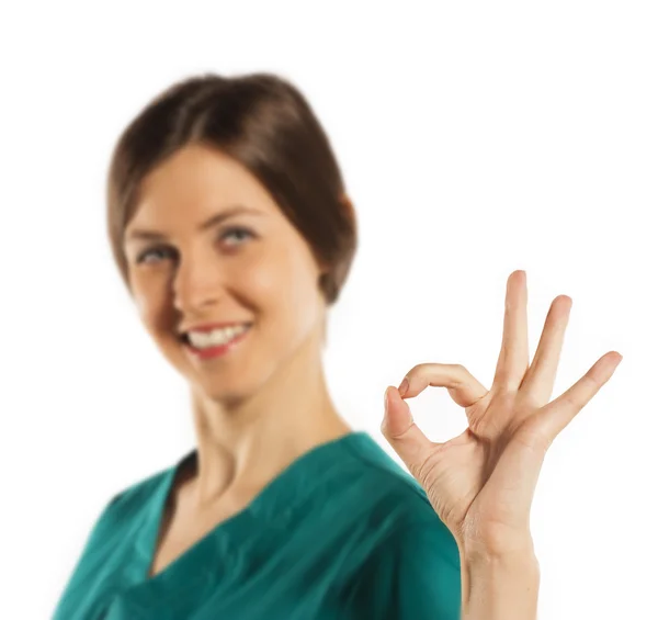 Young woman doctor giving thumbs up sign — Stock Photo, Image