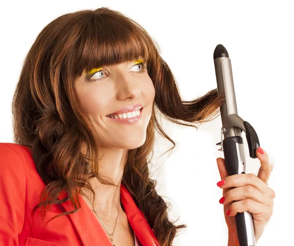 Beautiful woman curling her brunette hair — Stock Photo, Image