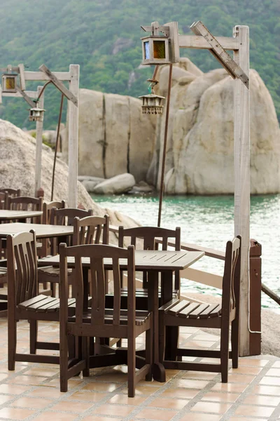 Empty tables in a cafe on the island of Koh Tao