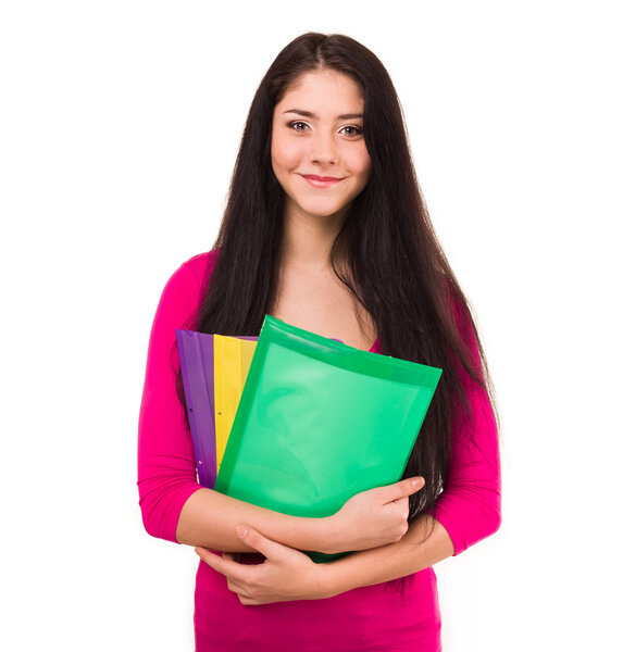 Cheerful young student with exercise books isolated on white background.