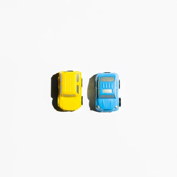 Yellow and blue cars on a white background. view from above